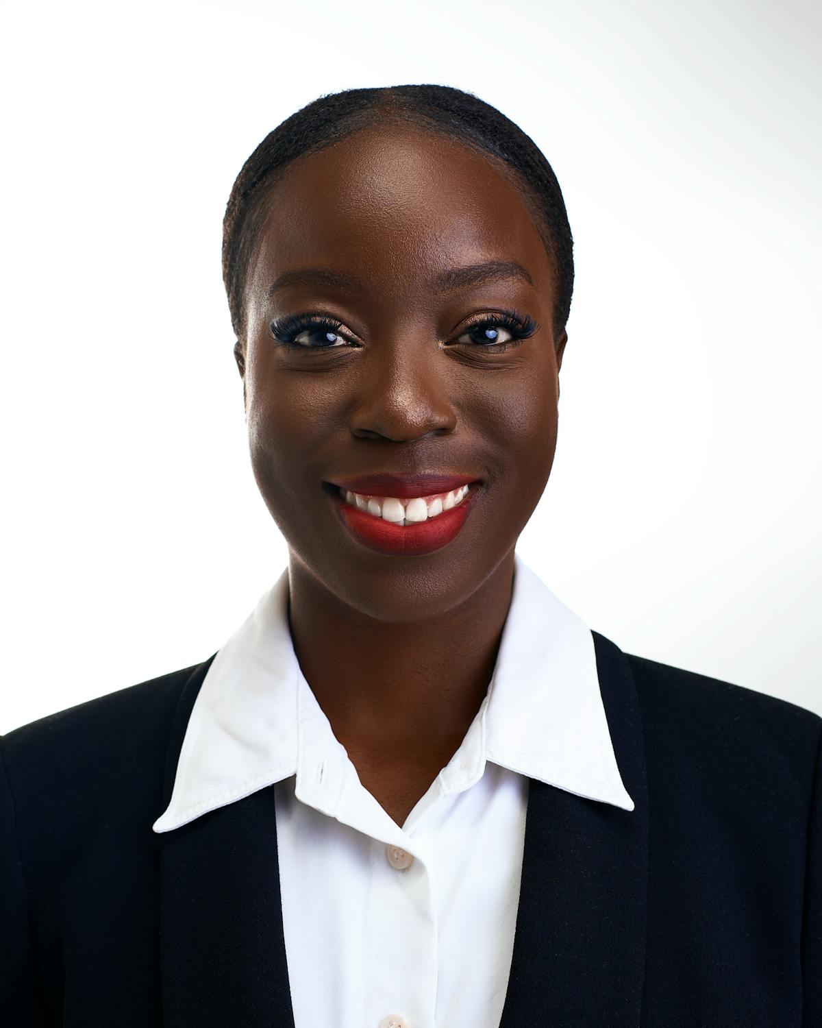 Corporate headshot of a woman in a white shirt and dark blazer